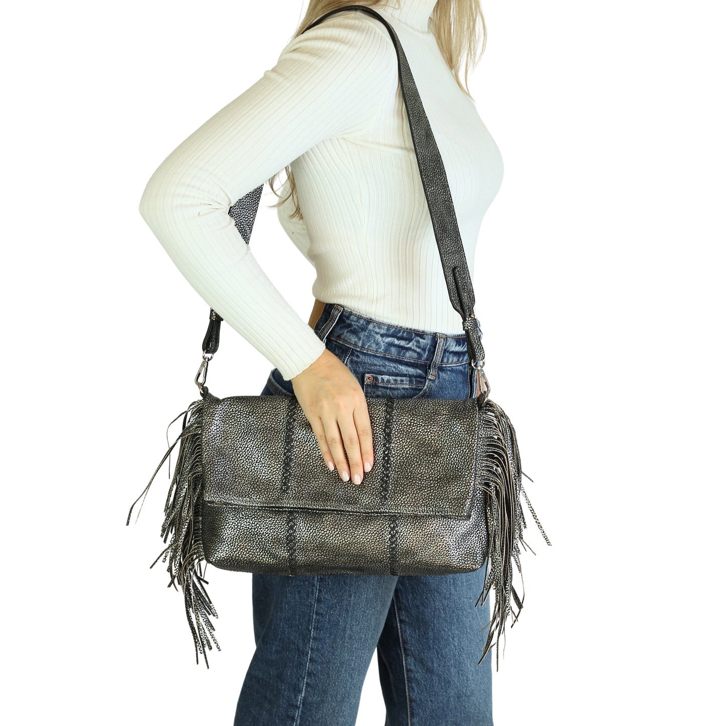 Close-up of the large fringe crossbody strap showcasing layered gold-tone metal strands and textured tassel detail from a