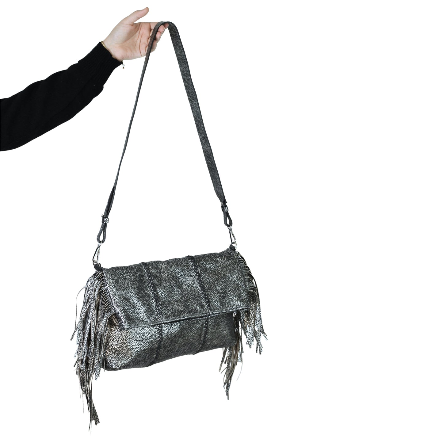Close-up of the large fringe crossbody strap’s textured leather and silver-toned metal chain detail from an angled bottom