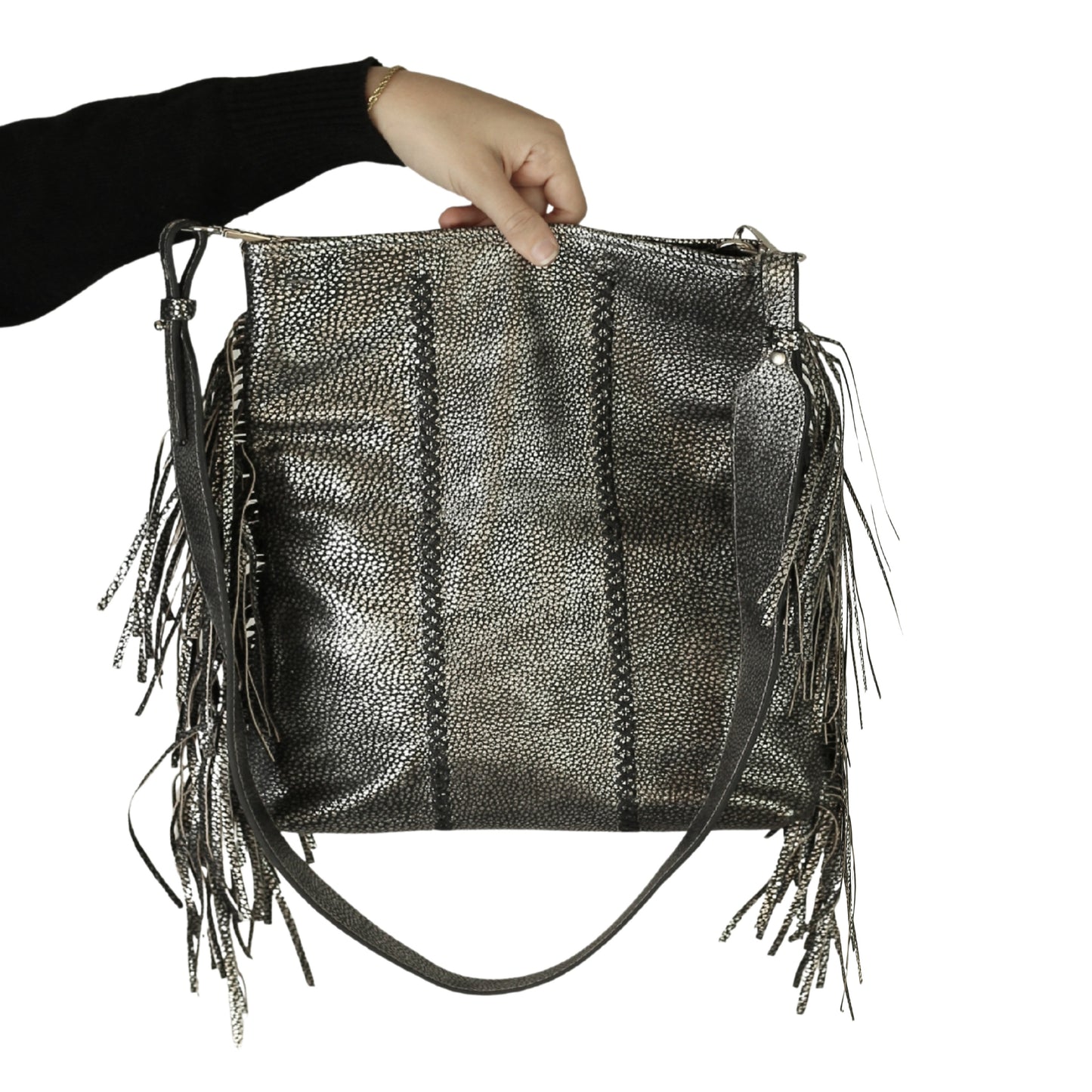 Close-up of the large gold-tone fringe crossbody strap with detailed chain links and textured tassel accents, showing