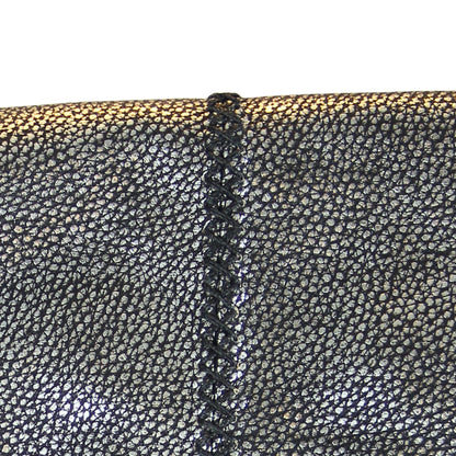 Close-up of the large gold-tone metal fringe detailing with layered chain links and adjustable clasp on the crossbody strap.