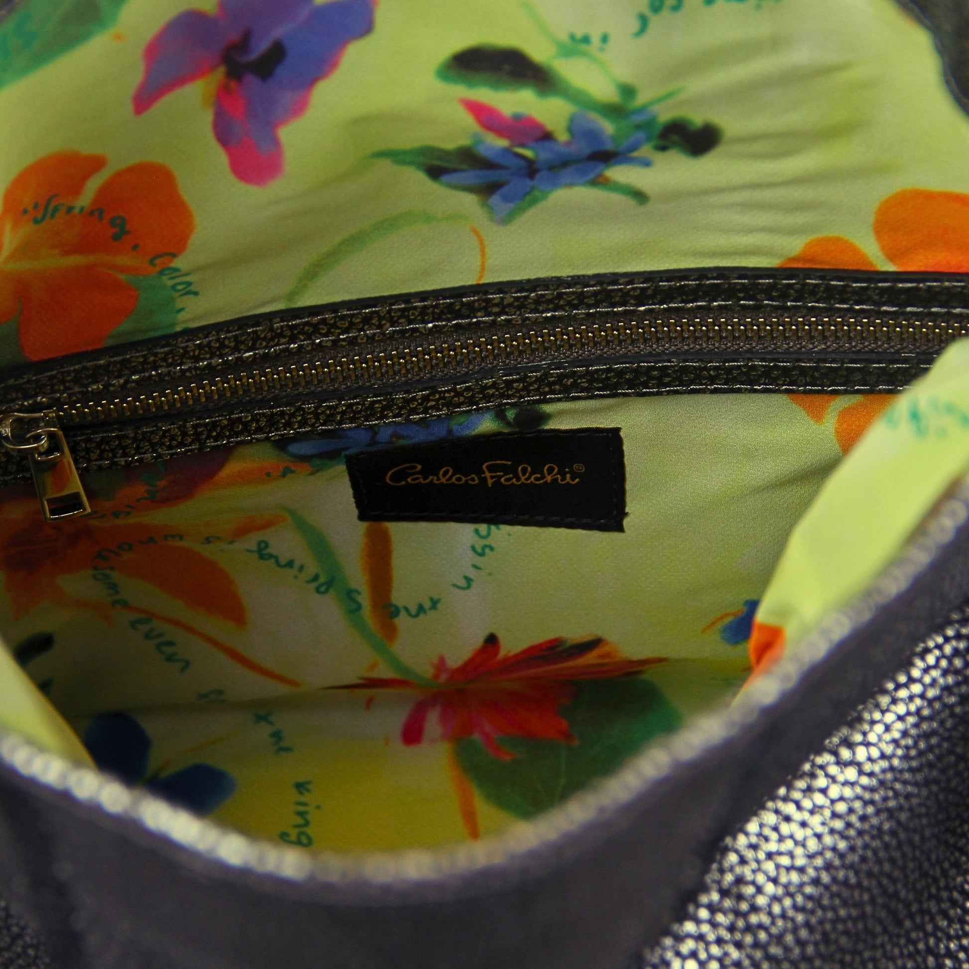 Close-up of the large fringe detailing and textured metal crossbody strap with lobster clasp, showcasing craftsmanship from