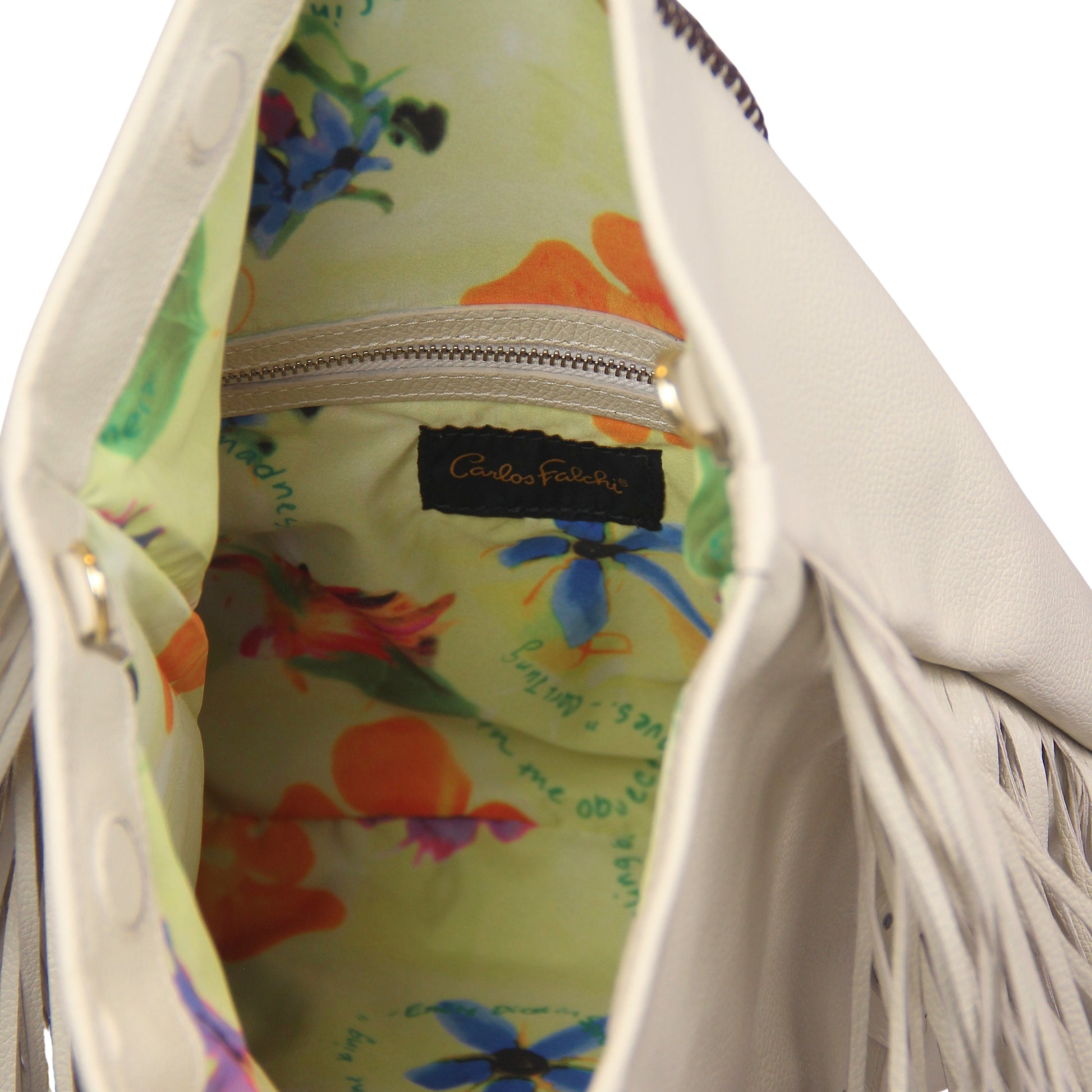 Close-up of the large gold-tone chain with fringed leather detailing, highlighting the textured metallic finish and layered