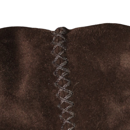 Close-up of the fringed leather strap detailing the textured stitching and subtle metal accents on the messenger flap.