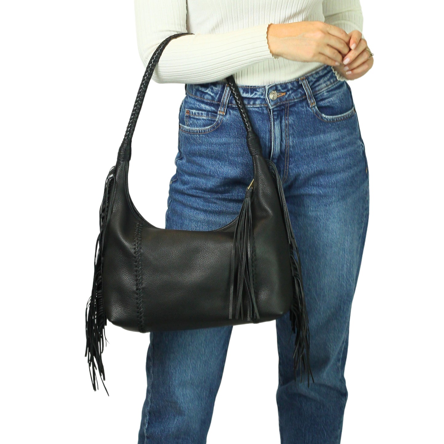 Close-up of the fringed leather texture and metal grommets on the fringe hobo bag at a slight downward angle, highlighting