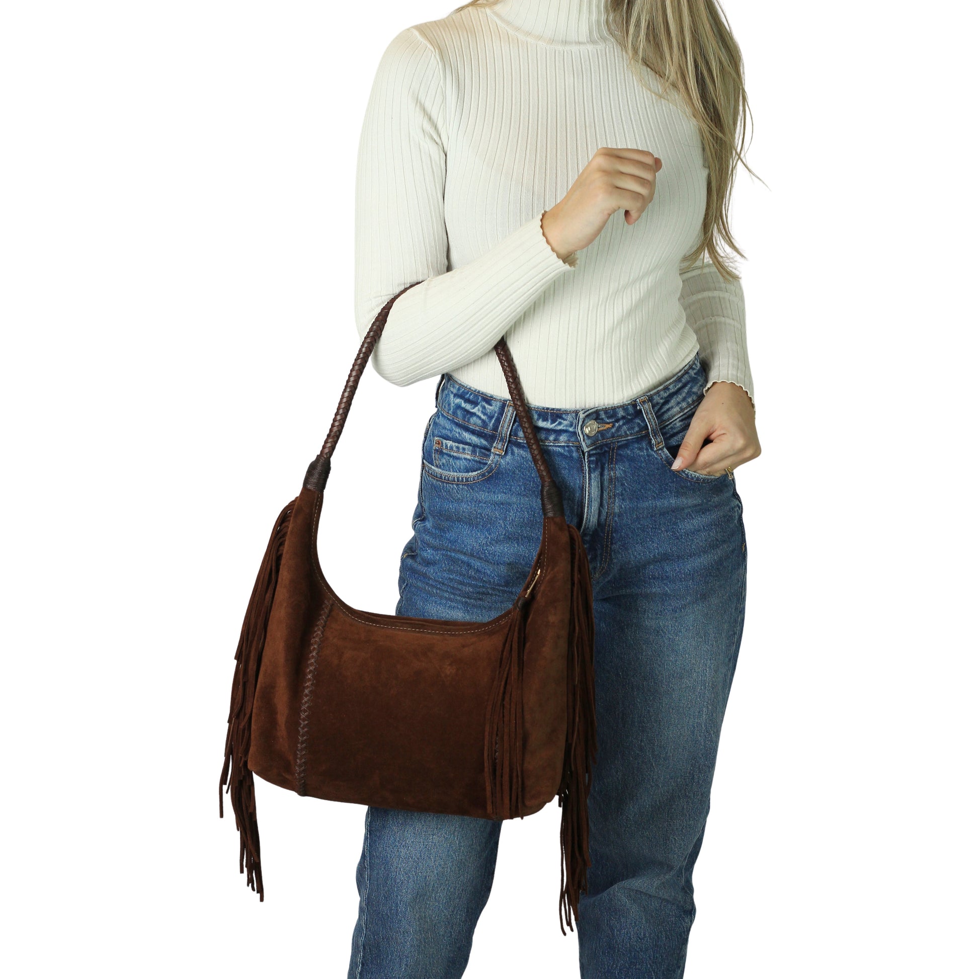 Close-up of the Fringe Hobo Bag’s antique brass zipper and textured leather strap detail from a slightly angled top-down