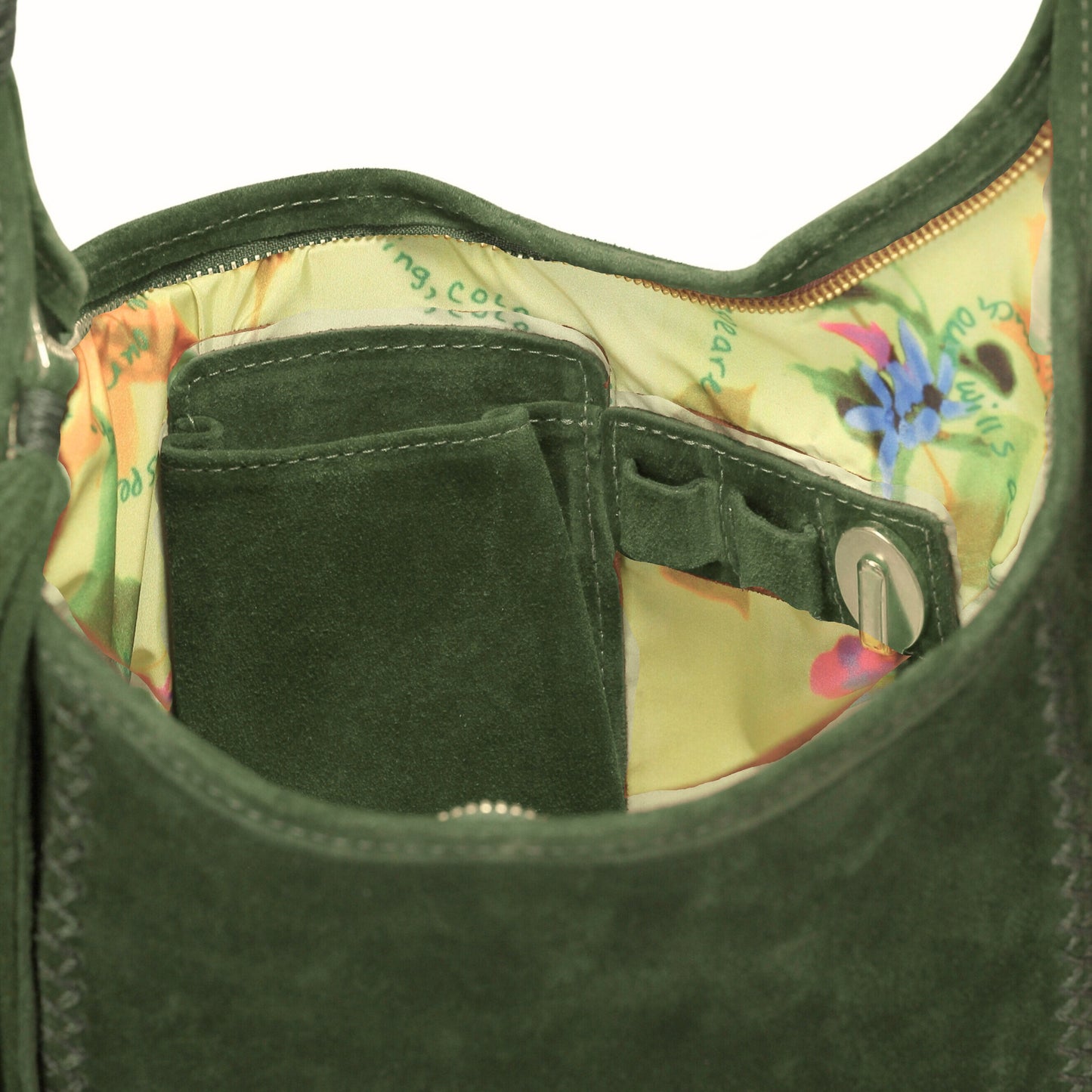 Close-up of the Fringe Hobo Bag's textured leather surface with visible metallic hardware and decorative fringe detail from