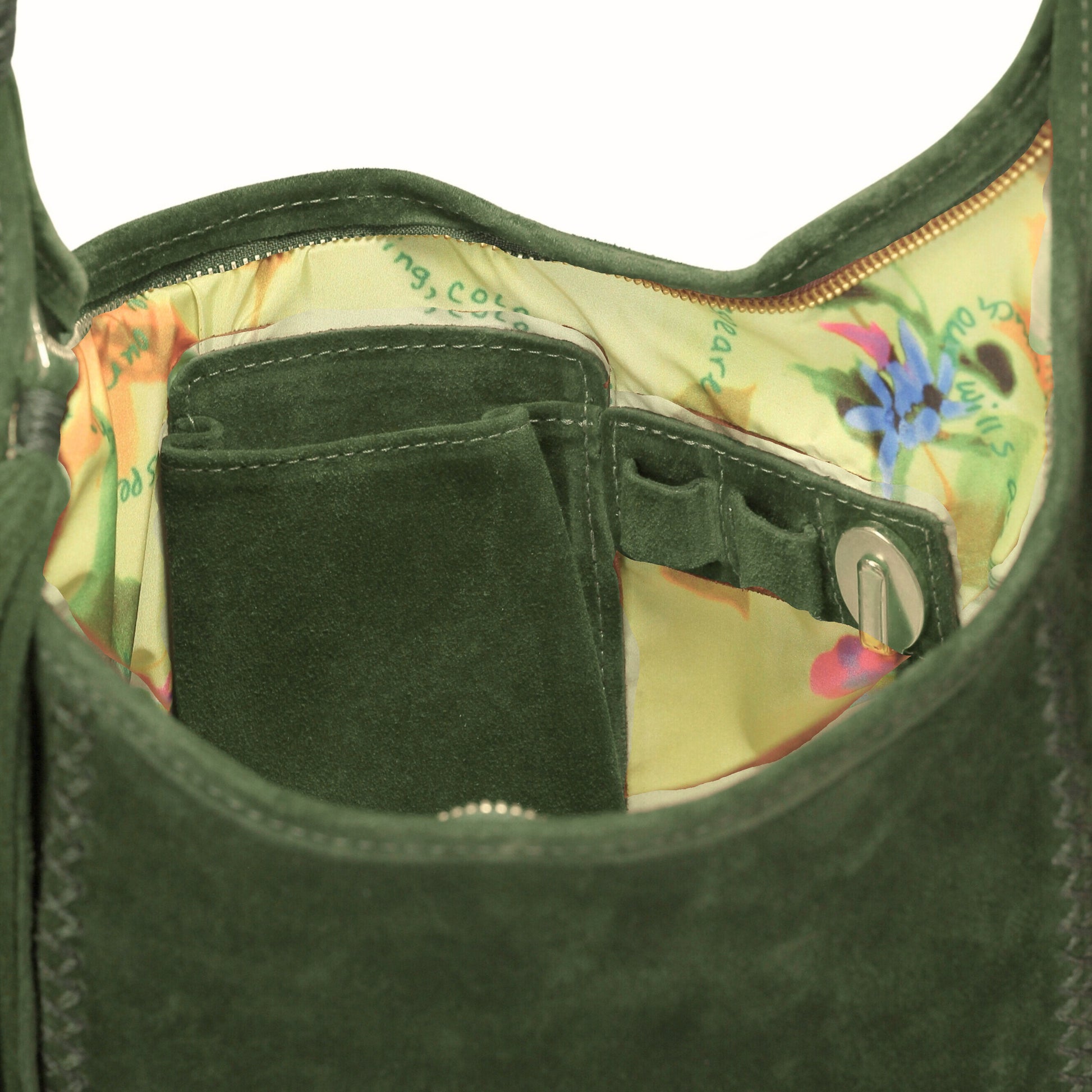 Close-up of the Fringe Hobo Bag's textured leather surface with visible metallic hardware and decorative fringe detail from