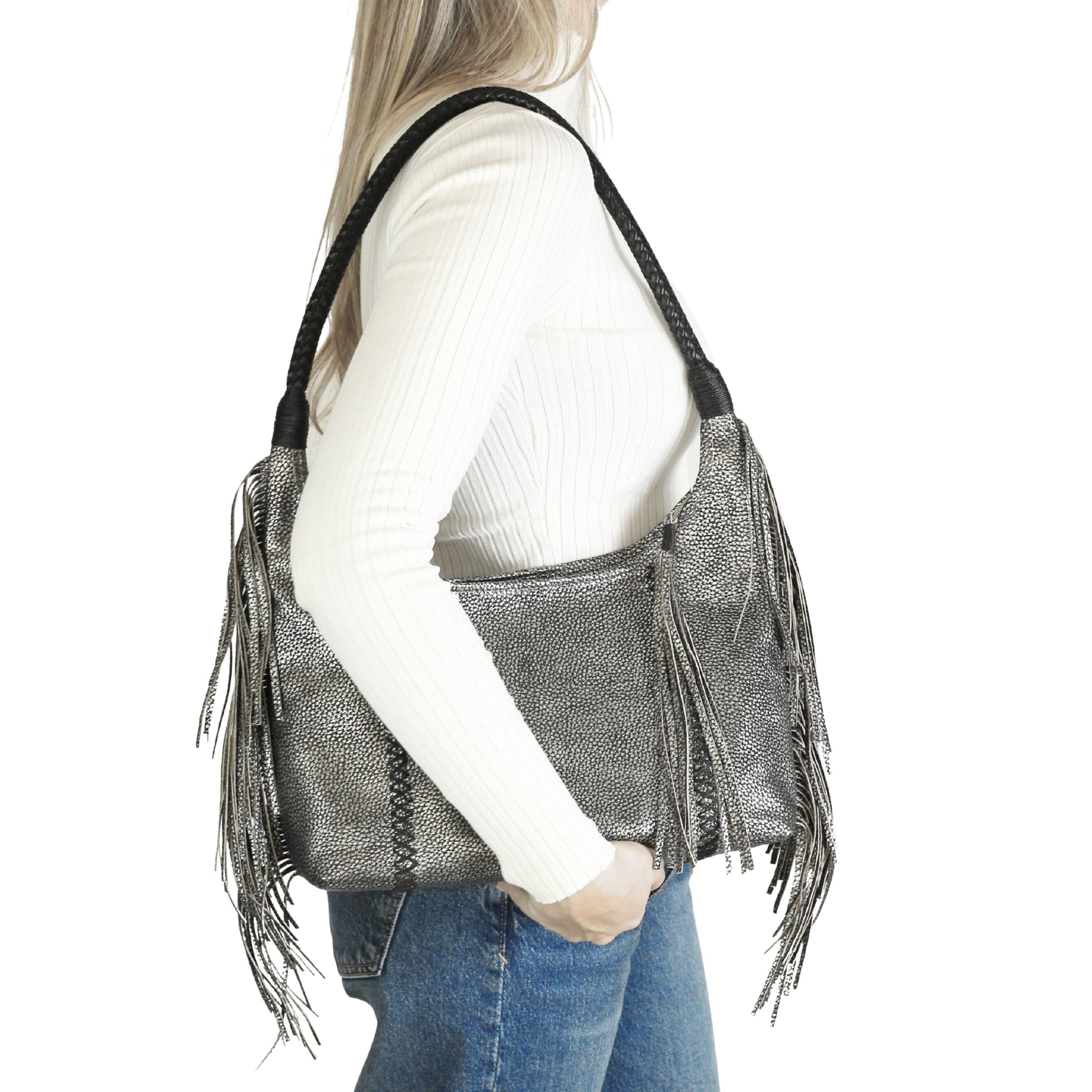 Close-up of the fringe hobo bag’s textured leather surface highlighting detailed stitching and layered fringe accents from a