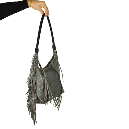 Close-up of fringed leather exterior highlighting textured tassels and metallic hardware detail on the Fringe Hobo Bag from