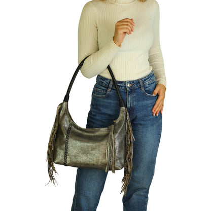 Close-up of the Fringe Hobo Bag's textured suede surface with metallic rivet accents and partial view of the metal chain