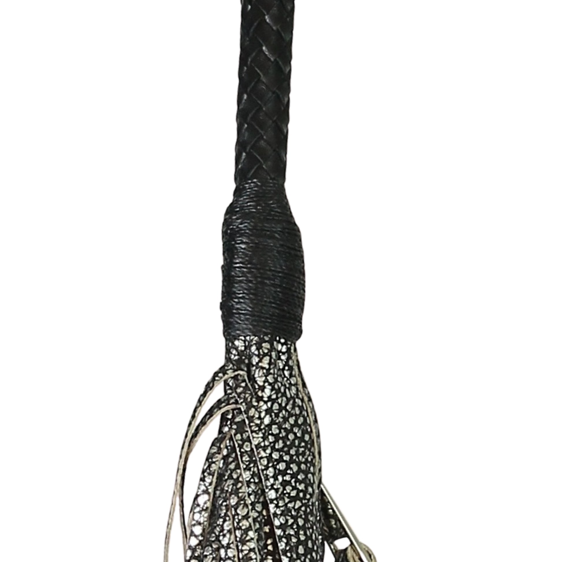 Close-up of the fringed leather texture and metal stud accents on the front flap of the Fringe Hobo Bag from a slightly