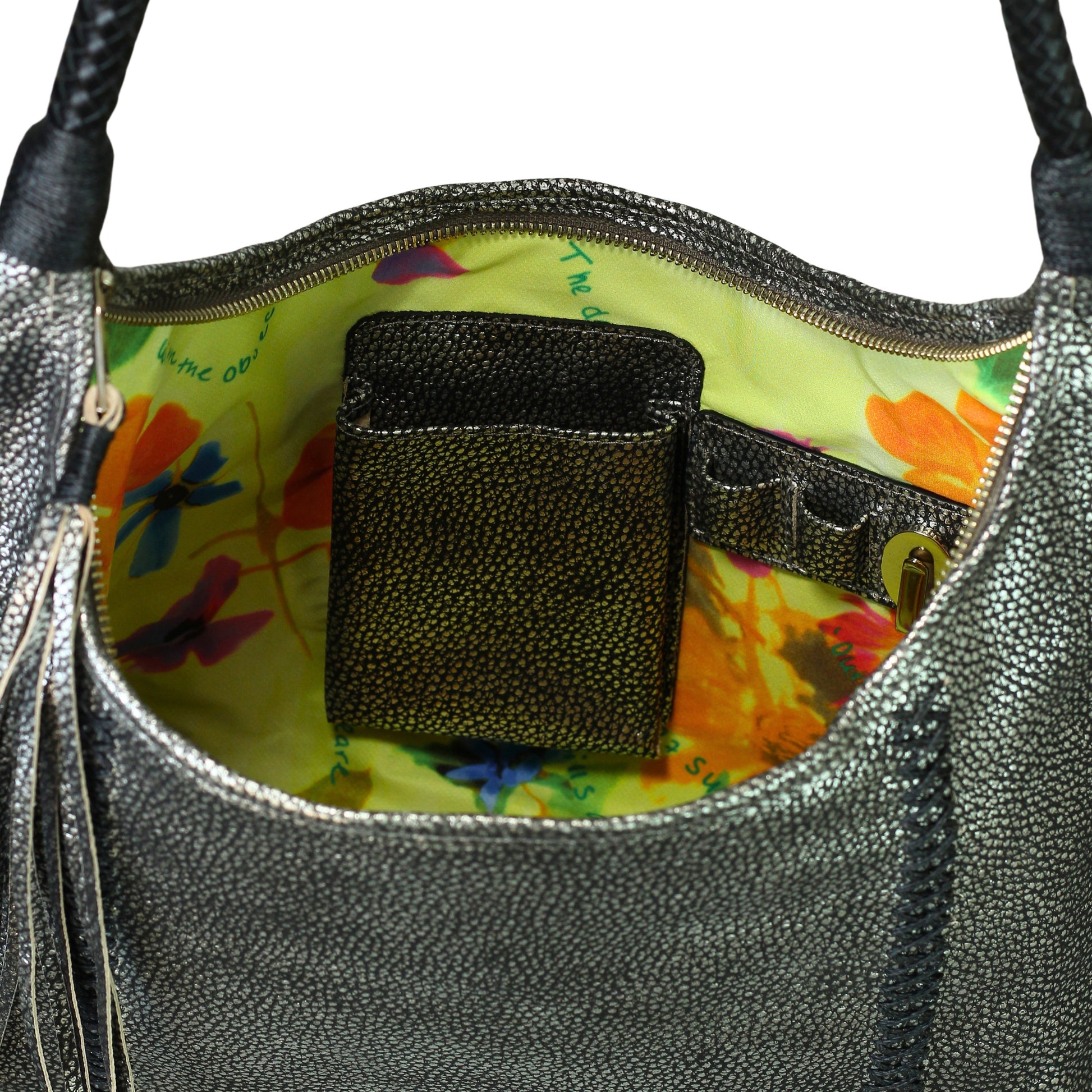 Close-up of the Fringe Hobo Bag's textured leather surface and decorative metal burst studs, highlighting craftsmanship