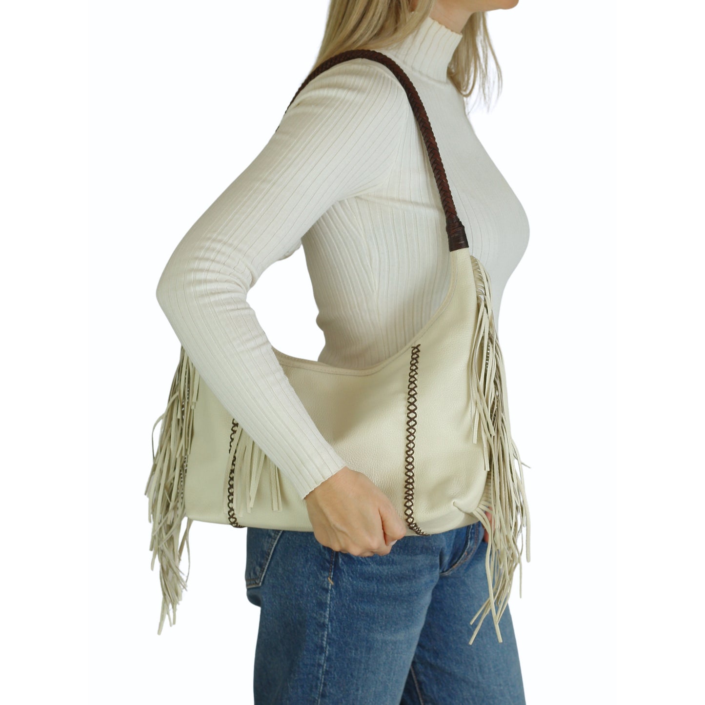 Close-up of the fringed leather exterior highlighting detailed craftsmanship and textured tassel accents on the Fringe Hobo