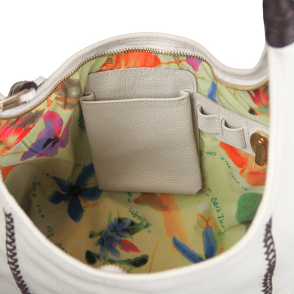 Close-up of gold-toned metal chain strap with textured fringe detail and subtle gemstone accents on the Fringe Hobo Bag.