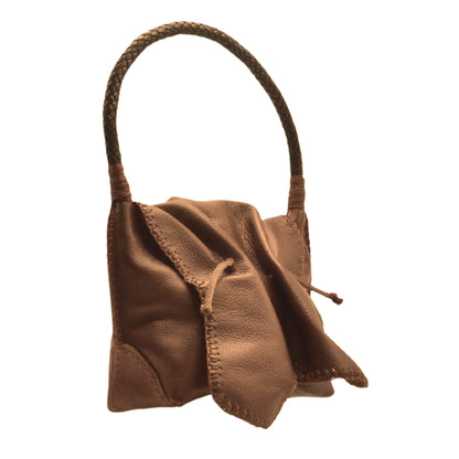 Close-up of the shoulder butterfly bag’s textured cream leather strap with gold-tone hardware attachment edge detail.